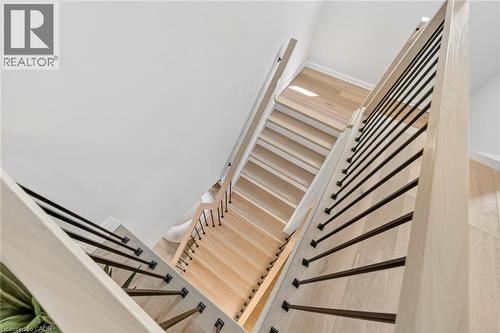 Hardwood staircase with light wood-finish treads and risers - 1533 Morse Place, Milton, ON - Indoor Photo Showing Other Room