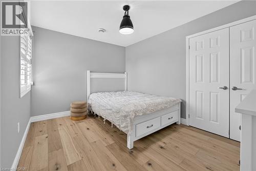 Light wood-finish flooring complements the neutral wall color in this room - 1533 Morse Place, Milton, ON - Indoor Photo Showing Bedroom