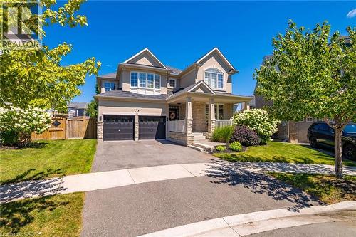 Two-story residence featuring a stone and stucco exterior, prominent gables, and a covered front porch with pillars - 1533 Morse Place, Milton, ON - Outdoor With Facade
