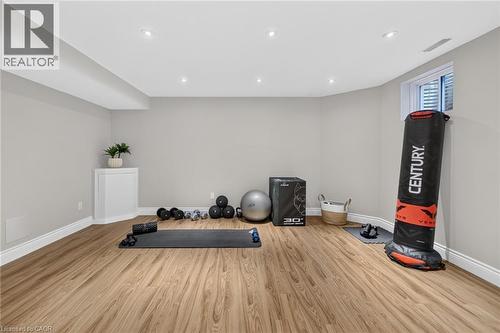 Spacious finished room featuring recessed lighting, light-toned walls, and wood-finish flooring - 1533 Morse Place, Milton, ON - Indoor