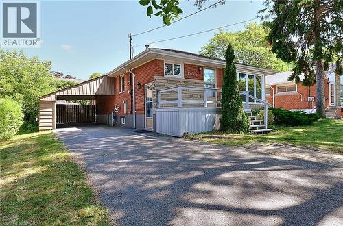Brick exterior featuring stone accents and a covered carport - 245 West 33Rd Street, Hamilton, ON - Outdoor