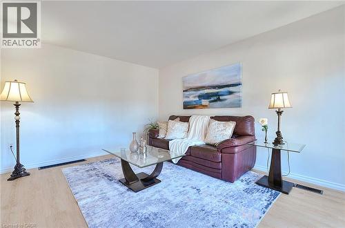 Bright living space featuring light wood-finish flooring and white baseboards - 245 West 33Rd Street, Hamilton, ON - Indoor Photo Showing Other Room