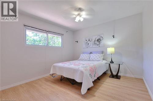Bright room featuring wood-finish flooring, a double window, and a ceiling fan with integrated lighting - 245 West 33Rd Street, Hamilton, ON - Indoor Photo Showing Bedroom
