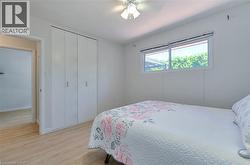 Light wood-finish flooring complements the neutral wall color - 