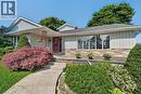 Exterior featuring a blend of brick and horizontal siding, a covered front entry, concrete walkway, and established landscaping - 134 Russ Road, Grimsby, ON  - Outdoor 