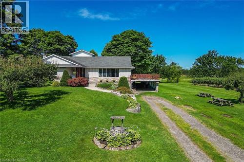 Single-story exterior featuring a partial stone facade, a covered entry, and a large front lawn - 134 Russ Road, Grimsby, ON - Outdoor