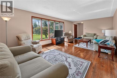 Living area featuring wood-finish flooring, a large picture window, and a white ceiling - 134 Russ Road, Grimsby, ON - Indoor Photo Showing Living Room