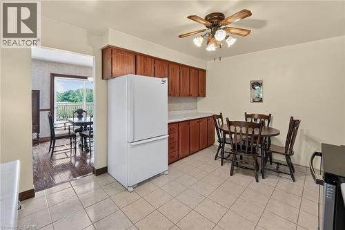 Kitchen featuring warm wood cabinetry, light-toned tiled flooring, and a ceiling fan with integrated lighting - 134 Russ Road, Grimsby, ON - Indoor