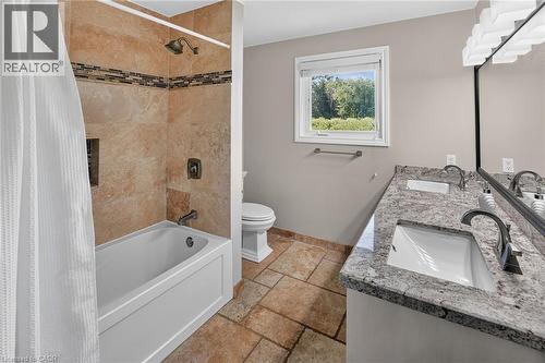 Full bathroom featuring a tub and shower combination with natural stone tile surround and decorative mosaic accent - 134 Russ Road, Grimsby, ON - Indoor Photo Showing Bathroom