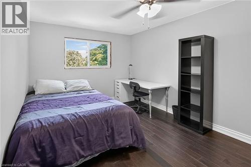 Bedroom featuring dark wood-finish flooring, light grey walls, and white baseboards - 134 Russ Road, Grimsby, ON - Indoor Photo Showing Bedroom
