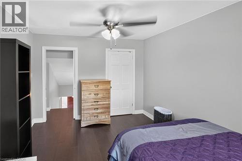 Interior room featuring dark wood-finish flooring, light grey walls, and white baseboards - 134 Russ Road, Grimsby, ON - Indoor Photo Showing Bedroom