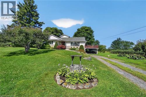 Ranch-style residence featuring a stone veneer facade and covered carport - 134 Russ Road, Grimsby, ON - Outdoor
