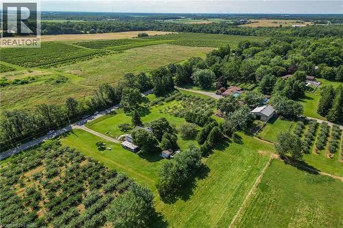 Expansive agricultural property featuring multiple cultivated fields, mature trees, a private drive, and an outbuilding with a metal roof - 134 Russ Road, Grimsby, ON - Outdoor With View