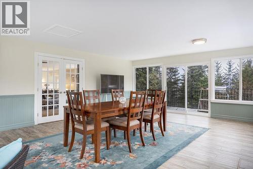 Sunroom facing back deck with patio doors. French doors to the kitchen/living room. - 2527 Islandview Road, Blind Bay, BC - Indoor Photo Showing Dining Room