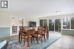 Sunroom facing back deck with patio doors. French doors to the kitchen/living room. - 