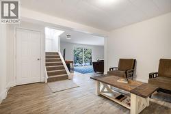 Flex space at the bottom of stairs in basement. Storage under staircase entrance to rec. room and other bedrooms/ powder room and laundry. Yard and garage/carport access. - 