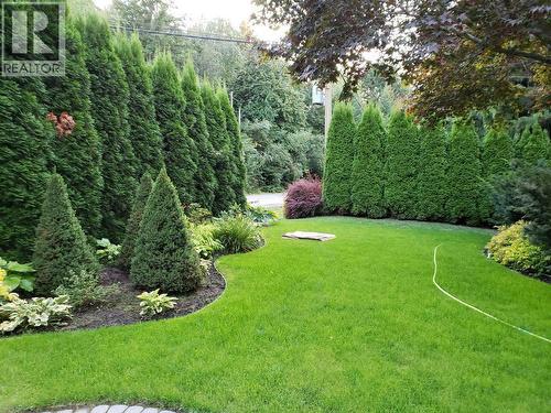 Front yard. Lots of privacy from road with the beautiful tall trees. Well taken care of landscape. - 2527 Islandview Road, Blind Bay, BC - Outdoor
