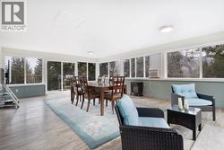 Sunroom. Large windows surround the sunroom for lots of light throughout the day. - 