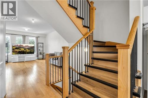 Hardwood staircase with black metal balusters and oak newel posts - 1451 Green Road, Bowmanville, ON - Indoor Photo Showing Other Room