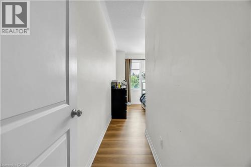 Hallway with wood-finish flooring and white baseboards - 1451 Green Road, Bowmanville, ON - Indoor Photo Showing Other Room