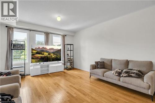 Bright interior space featuring wood-finish flooring, white walls, and a flat white ceiling - 1451 Green Road, Bowmanville, ON - Indoor Photo Showing Living Room