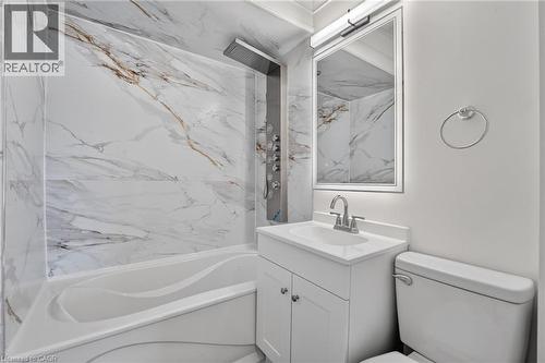 Bathroom featuring a white bathtub with a multi-function shower panel - 36 Mahony Avenue, Hamilton, ON - Indoor Photo Showing Bathroom