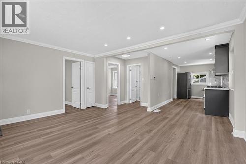 Open-concept living space with wood-finish flooring, recessed lighting, and crown molding - 36 Mahony Avenue, Hamilton, ON - Indoor