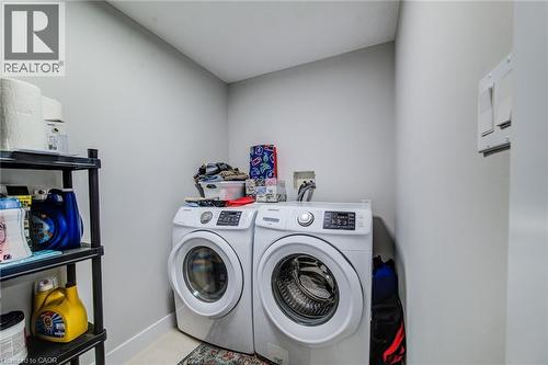 Dedicated laundry area with light gray walls and baseboards - 233 Red Clover Court, Kitchener, ON - Indoor Photo Showing Laundry Room