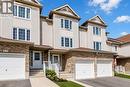 Multi-level townhome exterior featuring light-toned siding and brick accents - 233 Red Clover Court, Kitchener, ON  - Outdoor With Facade 