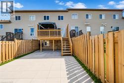 Expansive backyard oasis featuring a composite patio with linear inset detailing, newly constructed pressure-treated wood privacy fencing, and an elevated composite deck with integrated staircase and - 