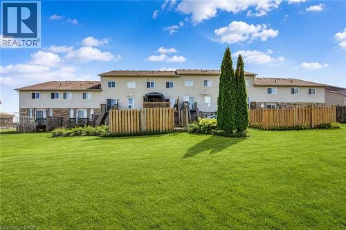 Expansive green lawn with established trees and wooden privacy fencing - 233 Red Clover Court, Kitchener, ON - Outdoor With Deck Patio Veranda