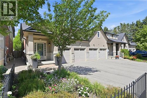 Stucco exterior with stone accents and multiple dormer windows - 10 Kopperfield Lane, Hamilton, ON - Outdoor
