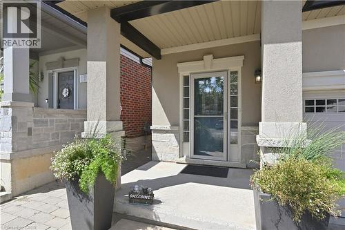 Stucco exterior with stone veneer accents and a covered entryway - 10 Kopperfield Lane, Hamilton, ON - Outdoor With Exterior