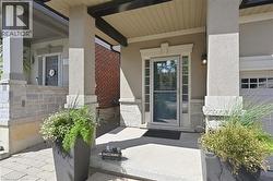 Stucco exterior with stone veneer accents and a covered entryway - 