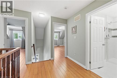 Upper-level hallway featuring wood-finish flooring, light gray wall paint, and white trim - 10 Kopperfield Lane, Hamilton, ON - Indoor Photo Showing Other Room