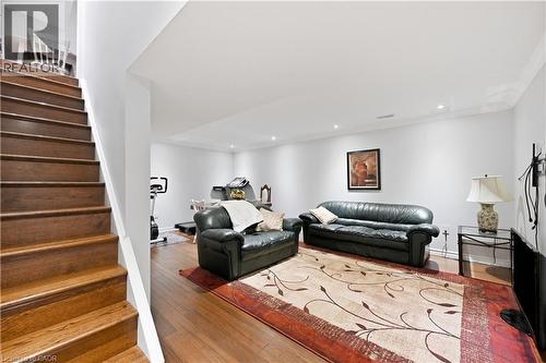 Spacious lower level featuring wood-finish flooring, recessed lighting, crown molding, and a built-in pony wall - 10 Kopperfield Lane, Hamilton, ON - Indoor