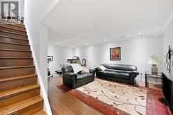 Spacious lower level featuring wood-finish flooring, recessed lighting, crown molding, and a built-in pony wall - 