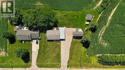 Aerial perspective showcasing a residential property with surrounding agricultural fields - 
