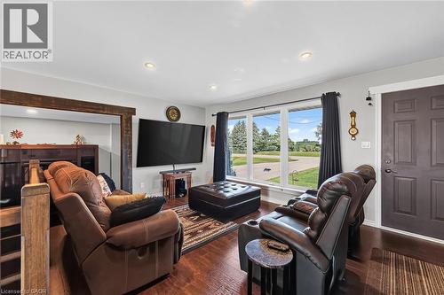Spacious room featuring wood-finish flooring, recessed lighting, and a prominent window offering exterior views - 184726 Cornell Road, Tillsonburg, ON - Indoor Photo Showing Living Room
