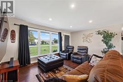 Living area with wood-finish flooring and recessed lighting - 