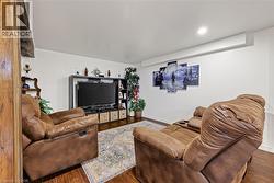 Finished interior space featuring wood-finish flooring, recessed lighting, and white walls - 