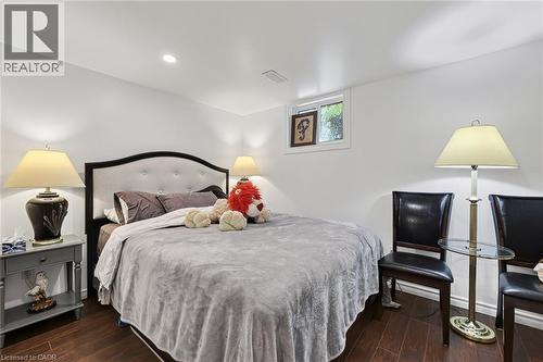 Bedroom featuring wood-finish flooring, recessed lighting, and a window providing natural light - 184726 Cornell Road, Tillsonburg, ON - Indoor Photo Showing Bedroom