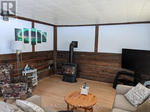 Cottage 4 - 743022 & 743024 Dawson Point Road, Timiskaming (Tim - Outside - Rural), ON - Indoor Photo Showing Living Room With Fireplace