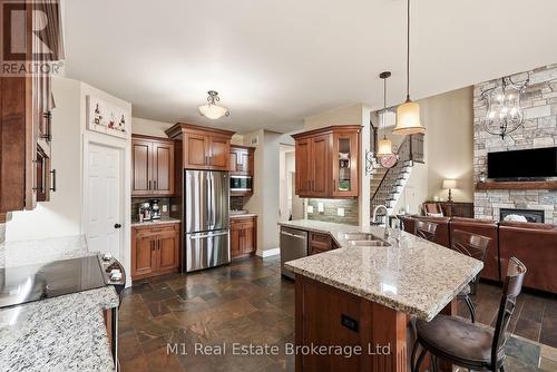 88 Conservation Trail, Centre Wellington (Belwood), ON - Indoor Photo Showing Kitchen With Fireplace With Double Sink