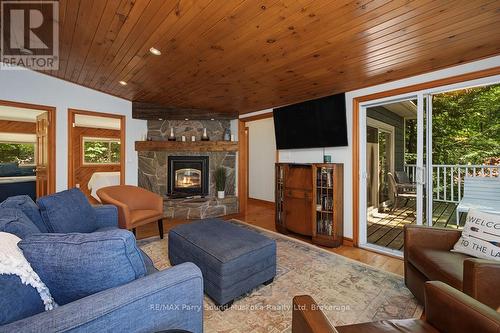 Living room w stone fireplace; access to deck - 13 Peak Path, Seguin, ON - Indoor Photo Showing Living Room With Fireplace