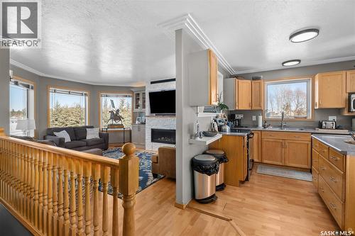 808 Lakeridge Drive, Buckland Rm No. 491, SK - Indoor Photo Showing Kitchen With Fireplace With Double Sink