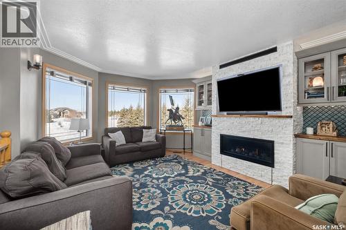 808 Lakeridge Drive, Buckland Rm No. 491, SK - Indoor Photo Showing Living Room With Fireplace