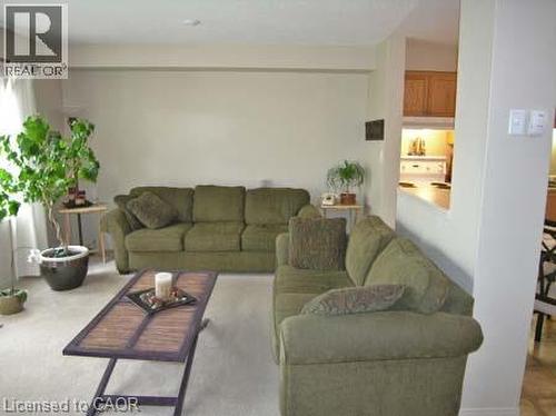 Living area featuring light-toned wall finishes and carpeting - 151 Clairfields Drive E Unit# 39, Guelph, ON - Indoor Photo Showing Living Room