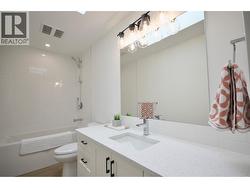 Main Bathroom with tile tub surround and quartz counters - 