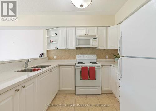 Lots of counters space and cupboards - Unit 201 - 115 Bond Street, Orillia, ON - Indoor Photo Showing Kitchen With Double Sink